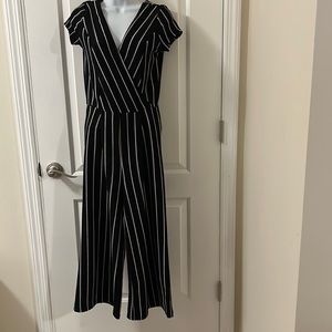 Jumpsuit Size medium. Black with white strips.